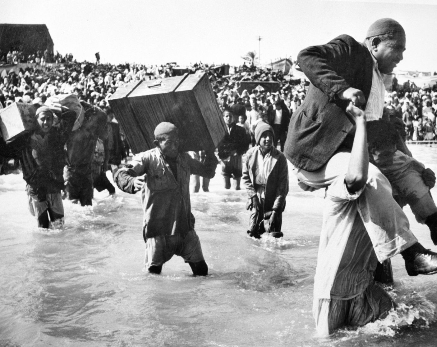 Palestine refugees initially displaced to Gaza board boats to Lebanon or Egypt, in 1949. Hrant Nakashian/1949 UN Archives